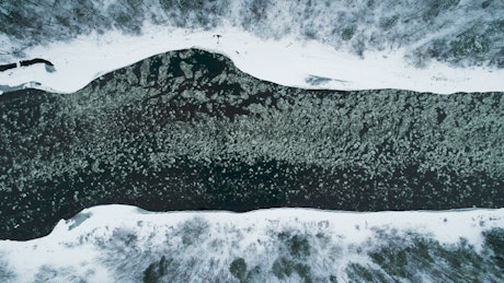 Aerial view of ice floes in a river in winter.