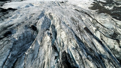 Aerial view over melting ice glacier in arctic.