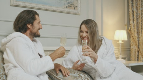 Affectionate couple toasting with wine.