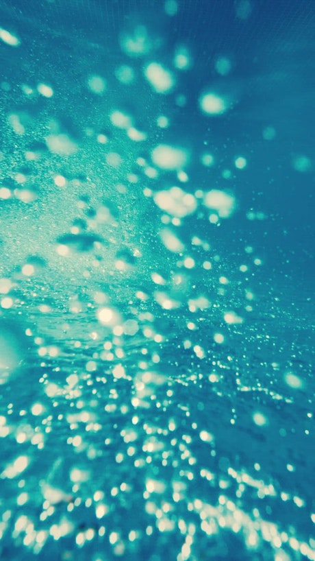 Air bubbles underwater, upside video.