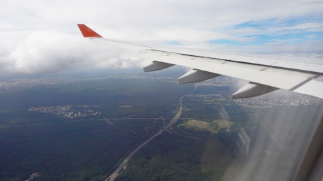 Airplane flying avobe tropical city