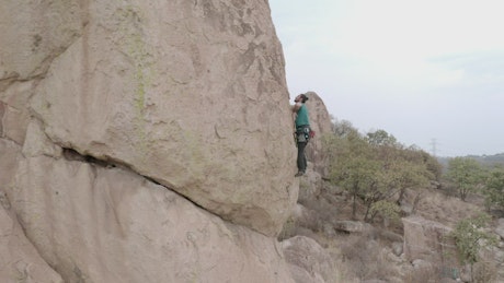 Alpinist climbing a vertical rock