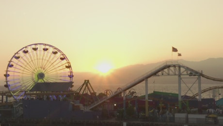 Amusement park in the beach at sunset.