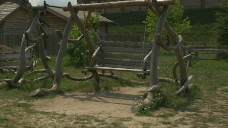 An elaborate wooden swing moving