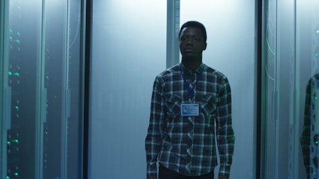An engineer arrives to the computer in data center.