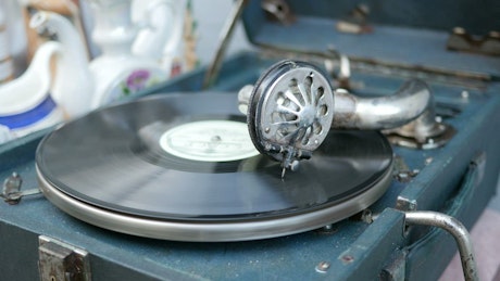 An old vinyl turntable in a case.