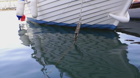Anchor rope of a boat coming out of the water.