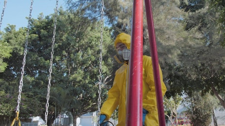 Antivirus staff disinfecting a swing