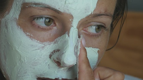 Applying a beauty mask close-up.