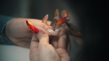 Applying nail polish to clients hand