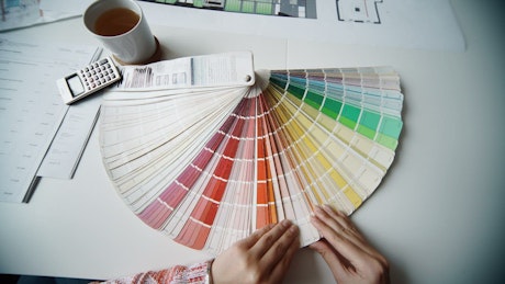 Architect choosing a color from the color plate.