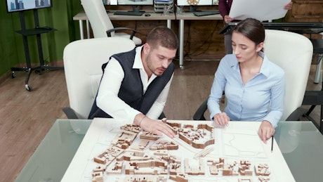 Architects collaborate on project ideas with 3d model
