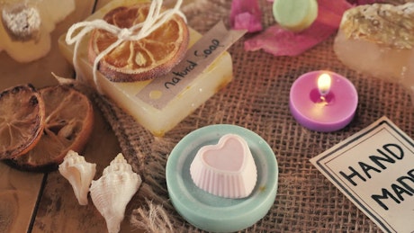 Arrangement of natural soaps and candles.