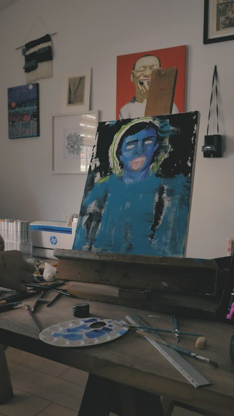 Artist painting an abstract portrait.