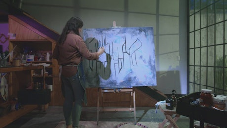 Artist woman painting in her art studio