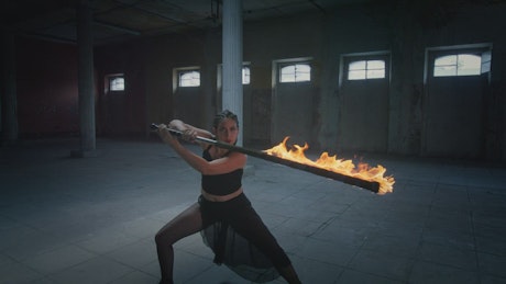 Artistic dance of a woman with a fire saber
