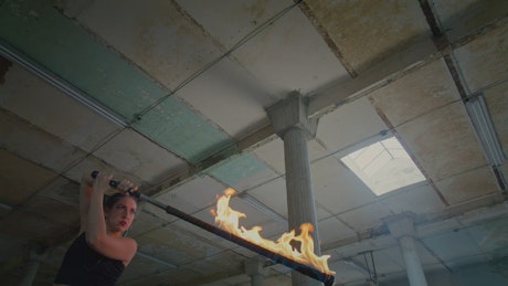 Artistic dance of a woman with a saber in fire.