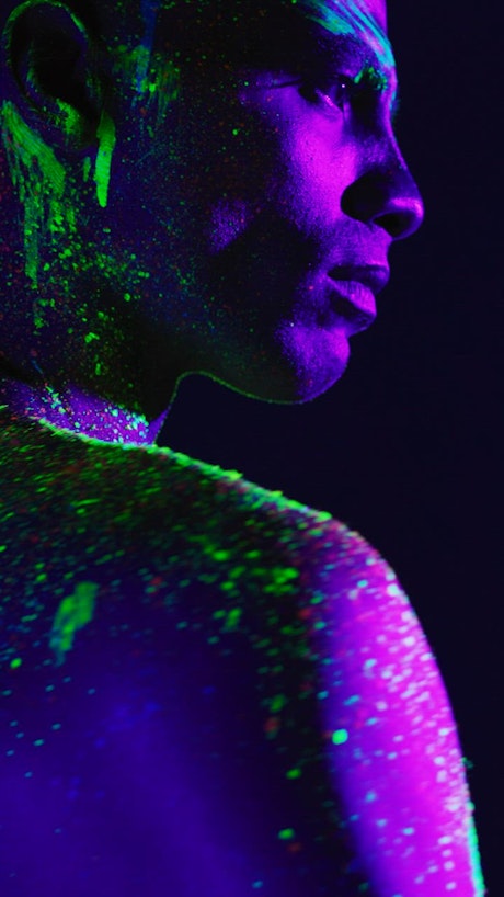 Artistic portrait of a man stained with phosphorescent paint.