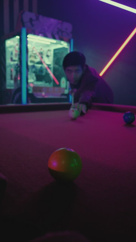 Asian young man playing pool.