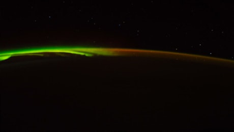Aurora lights glowing along the surface of Earth.
