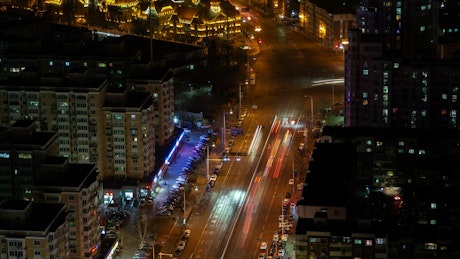 Avenue packed with cars in a city at night.