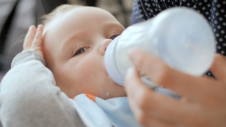 Baby drinking form the milk bottle.