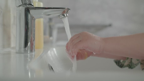 Baby washing hands.