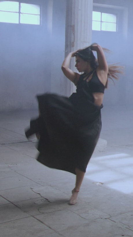 Ballerina in black skirt performing a dance.