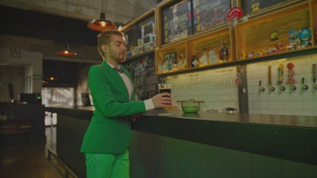 Bar with a man drinking on st patrick's day.