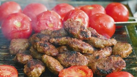 Barbecued food tomatoes and meat.
