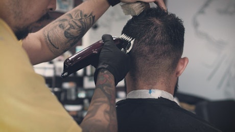 Barber cutting hair.