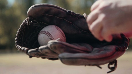 Baseball glove and the player with the ball