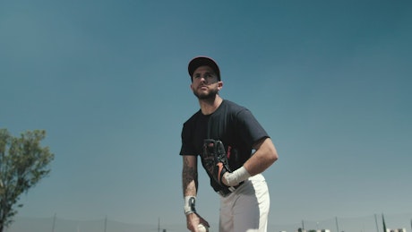 Baseball player pitching the ball.
