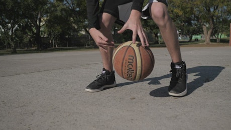 Basketball player dribbling ball.