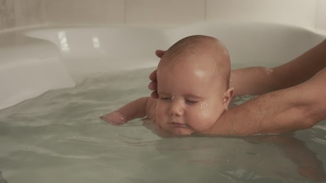 Bathing a newborn baby.