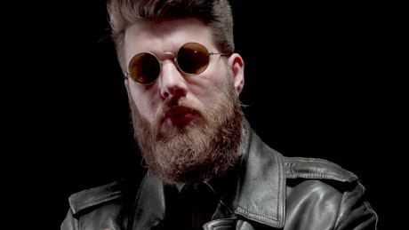 Bearded man in leather jacket smoking