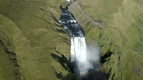 Beautiful powerful waterfall in Iceland with rainbow.