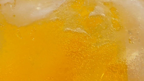 Beer bubbles floating upward on a crystal glass.