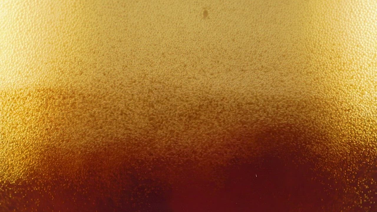 Beer foam forming in a LIVE DRAW  glass seen from close up