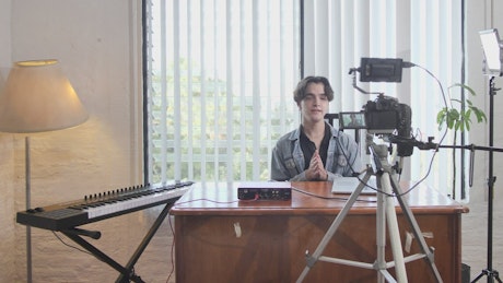 Behind the scenes of a young man recording a video.