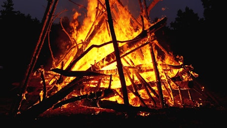 Big bonfire burning in the night.