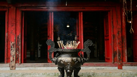 Big pot of burning incense.