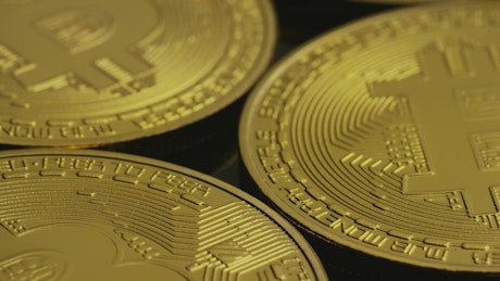 Bitcoin coins rotating in a close-up shot.