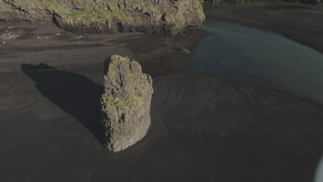 Black sand beach rock formation.