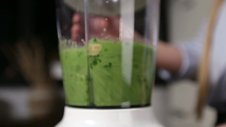 Blending a green smoothie