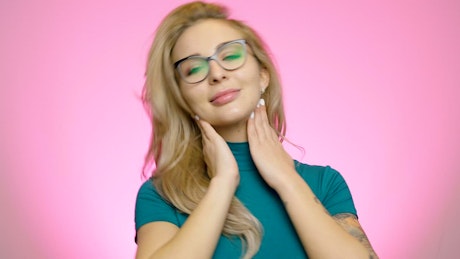 Blond woman with glasses poses to the camera