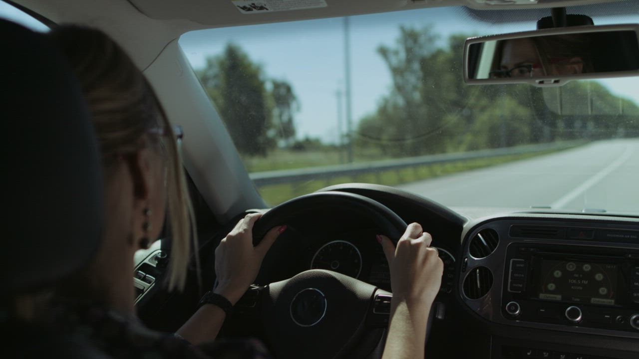 Blonde woman driving on  LIVE DRAW road