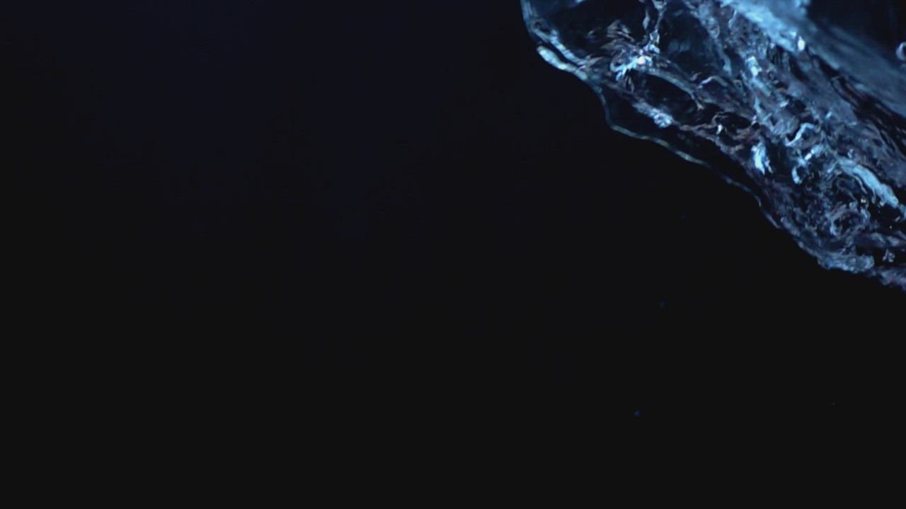 Blue water on a black background - Free Stock Video