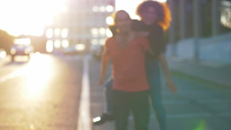Blurred video of a couple embracing in the street.