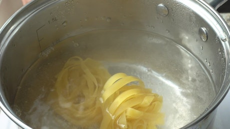 Boiling pasta in a large pan.